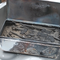 making charcoal- opening the tin